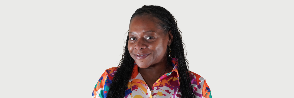 headshot of a woman in a blue and orange blouse